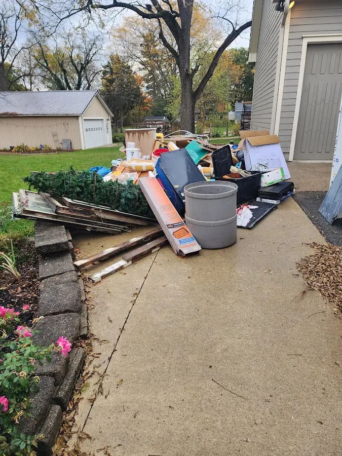 Dumpster being loaded with debris for 12 Yard Dumpster Rental in Swansea